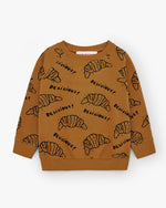 Load image into Gallery viewer, Brown jumper with all-over prints of croissants. Comes with ribbed cuffs and brushed cotton from the inside for extra warmth. Brand name is Nadadelazos
