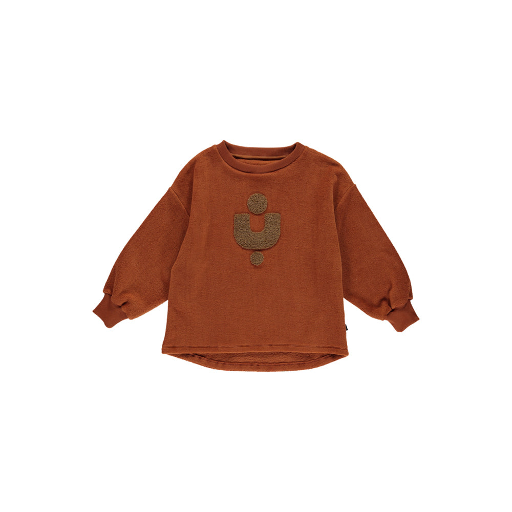 Fleece Pullover in Copper made with 100% organic cotton. The front has an abstract shape in the center. It has a fleecy feel on the inside for extra coziness. Made by Monkind