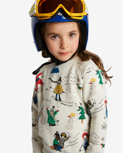 Little girl wearing white jumper with various prints of kids skiing. Comes with ribbed cuffs and brushed cotton from the inside for extra warmth. Made by Nadadelazos