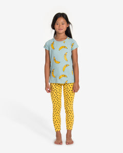 Model is wearing Turquoise T-shirt with a yellow bananas all-over print. Comes with a folded cuffs. Made by Nadadelazos