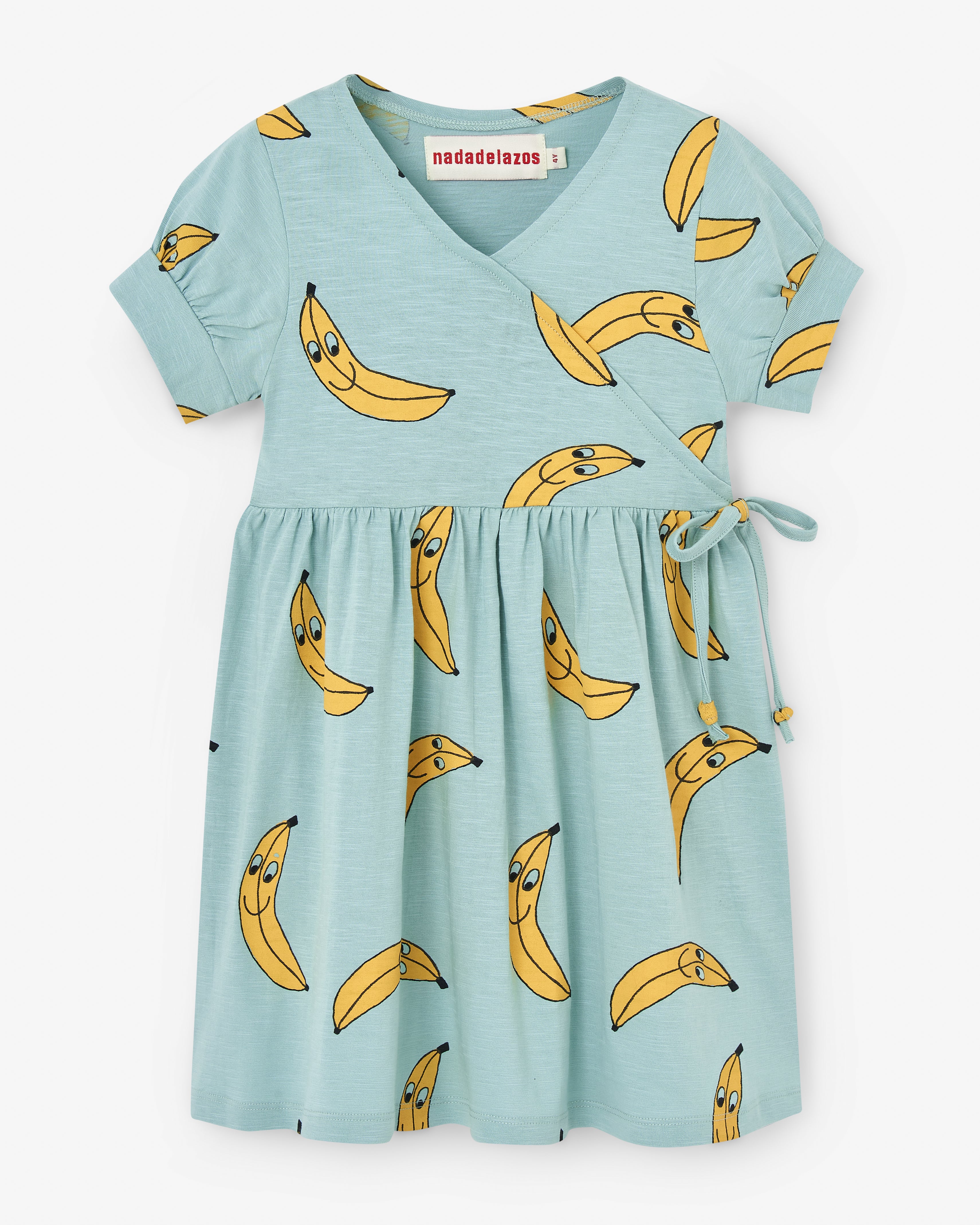 Turquoise double-breasted dress with an all-over print of yellow bananas. The wrap detail is fixed and makes the dress very comfy to put on and off. 100% certified organic cotton. 100% pollution-free water print. Made by Nadadelazos