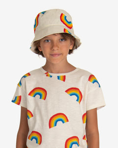 Model wearing Off-white sun hat with rainbow all-over print. Made by Nadadelazos