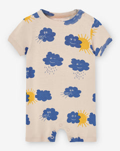 Light cream romper with blue clouds and yellow sun print. It comes with a shoulder opening. Made by Nadadelazos
